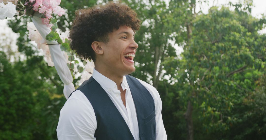 Joyful Man in Garden Celebrating Outdoor Wedding Ceremony