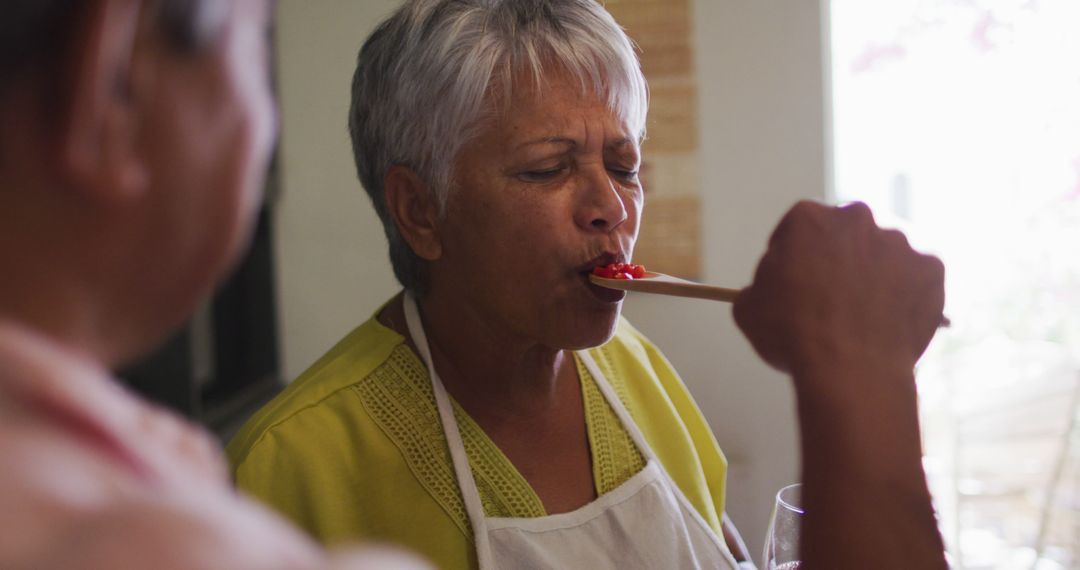 Elderly Woman Tasting Soup with Wooden Spoon - Free Images, Stock Photos and Pictures on Pikwizard.com