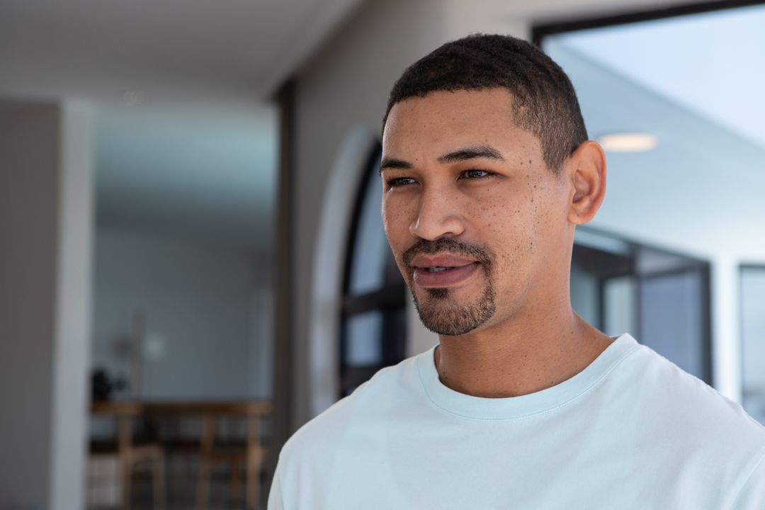Confident Young Man Relaxing in Minimalist Living Space