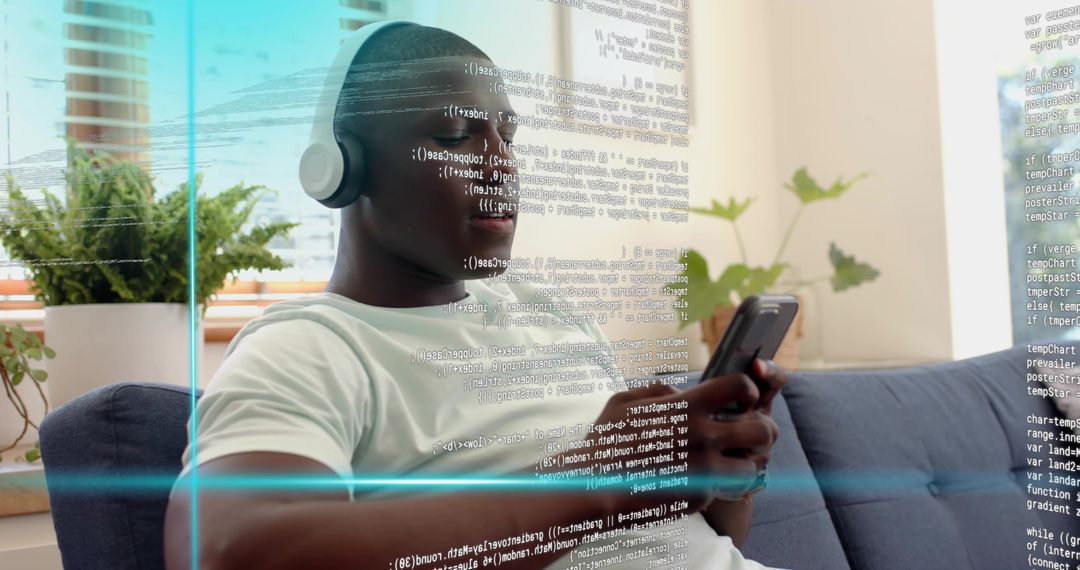 Man Relaxing on Sofa with Headphones Reading Code on Smartphone with Digital Overlay