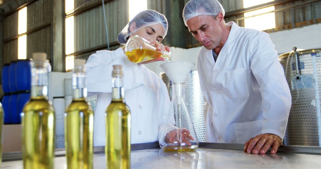 Quality Control Technicians Testing Olive Oil in Modern Laboratory - Free Images, Stock Photos and Pictures on Pikwizard.com