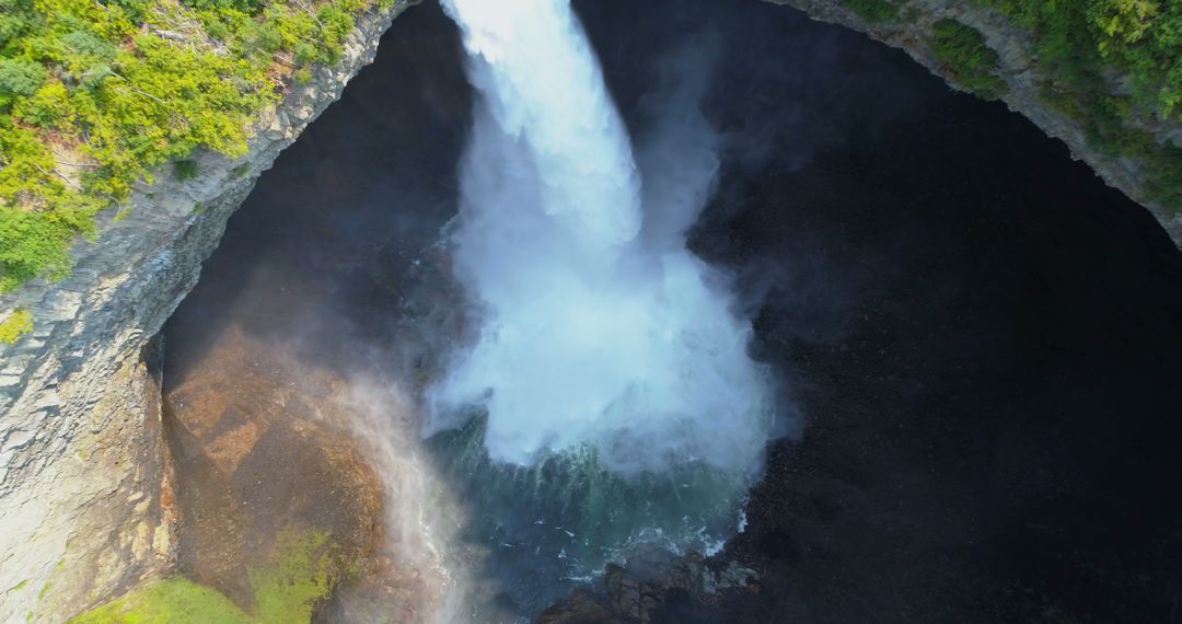 Aerial View of Powerful Waterfall Cascading into Deep Gorge - Free Images, Stock Photos and Pictures on Pikwizard.com