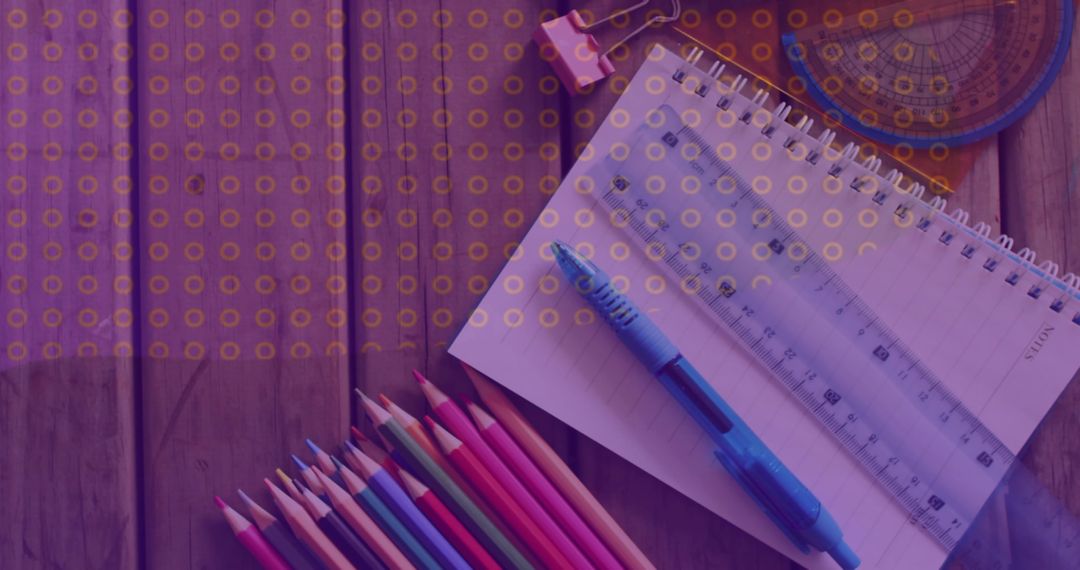 Creative Workspace with Spiral Notebook and Colored Pencils