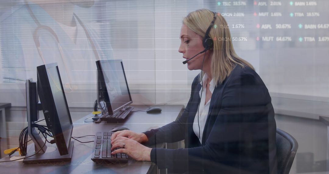 Caucasian Businesswoman Working on Desktop with Headset in Office