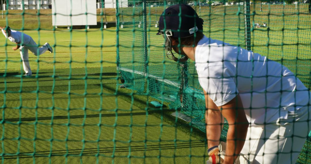 Cricketers Practicing in Nets on Sunny Day - Free Images, Stock Photos and Pictures on Pikwizard.com