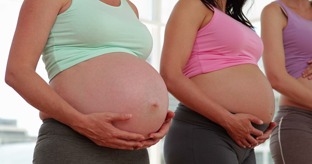 Pregnant Women Holding Bellies During Group Exercise - Free Images, Stock Photos and Pictures on Pikwizard.com