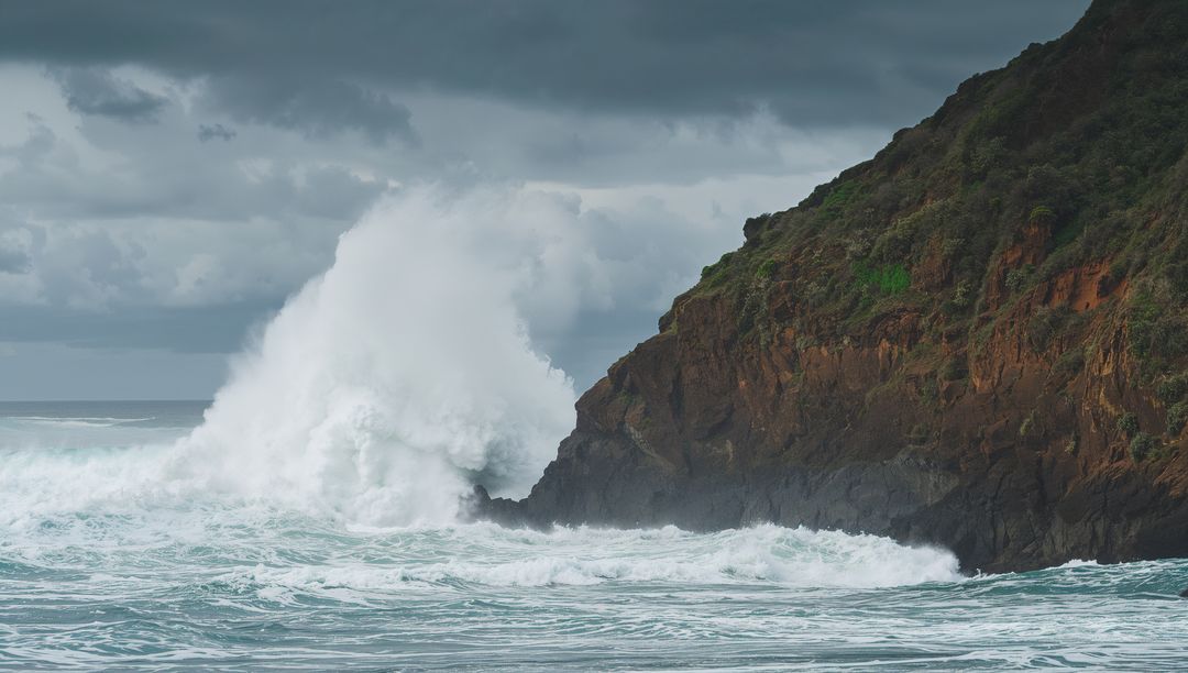Dramatic Wave Crashing Against Rocky Cliff under Stormy Sky