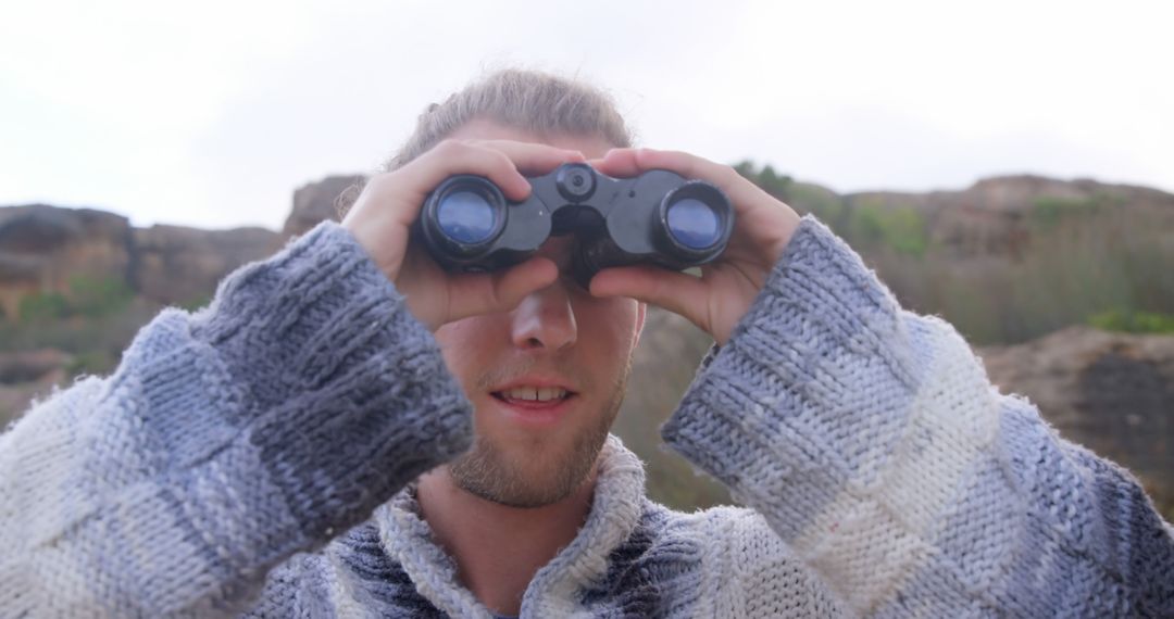 Man Using Binoculars for Bird Watching in Natural Landscape - Free Images, Stock Photos and Pictures on Pikwizard.com