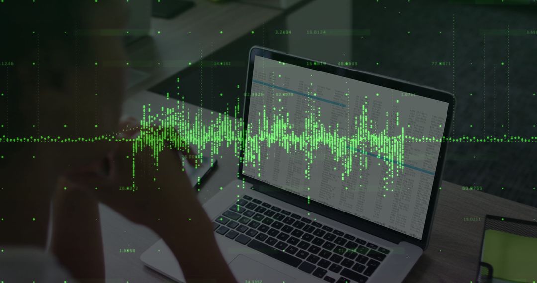 Woman Analyzing Dynamic Data on Laptop at Modern Office Workspace