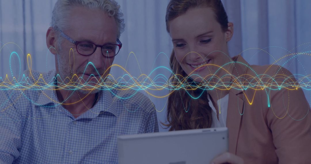 Two Colleagues Analyzing Digital Data on Tablet in Modern Office Setting