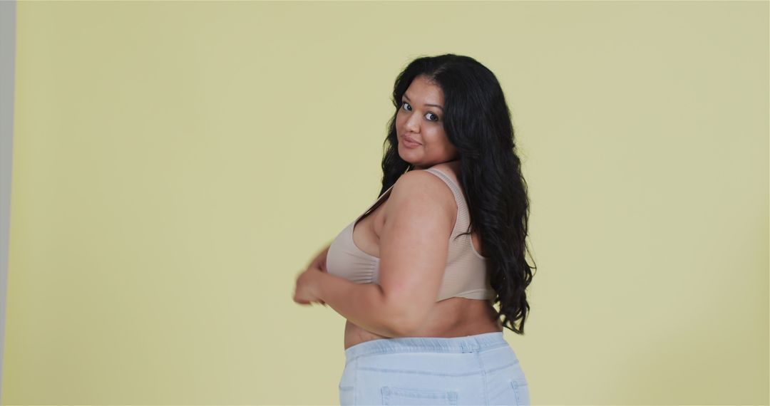 Confident Plus-Size Woman Posing in Studio with Stylish Attire