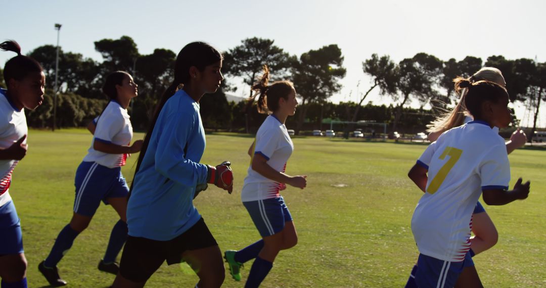 Female Soccer Team Practicing on Field Under Sunny Skies - Free Images, Stock Photos and Pictures on Pikwizard.com