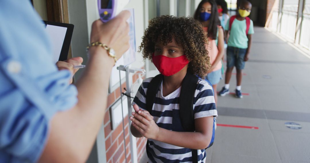 Kids in Masks Lining Up for Temperature Check at School Entrance