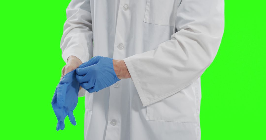 Doctor Putting on Blue Latex Gloves in Front of Green Screen - Free Images, Stock Photos and Pictures on Pikwizard.com