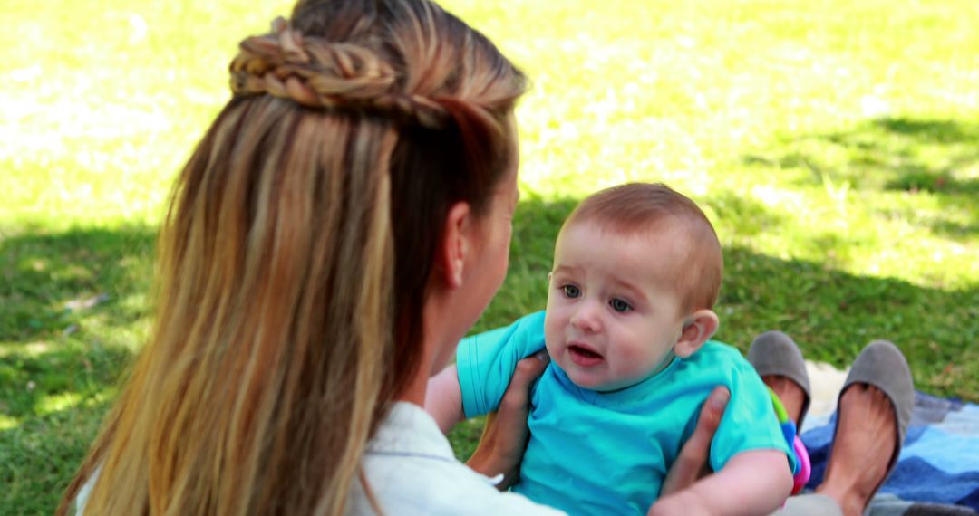 Mother Holding Baby Outdoors on Sunny Day - Free Images, Stock Photos and Pictures on Pikwizard.com