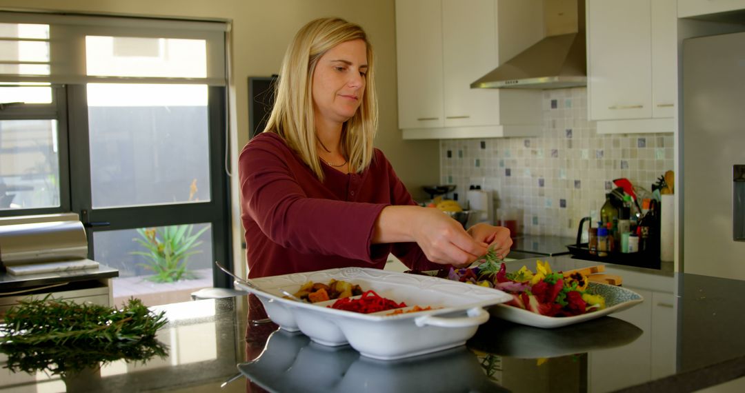 Woman Preparing Fresh Salads in Modern Kitchen - Free Images, Stock Photos and Pictures on Pikwizard.com