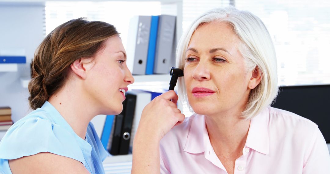 Doctor Examining Senior Woman's Ear in Medical Office - Free Images, Stock Photos and Pictures on Pikwizard.com