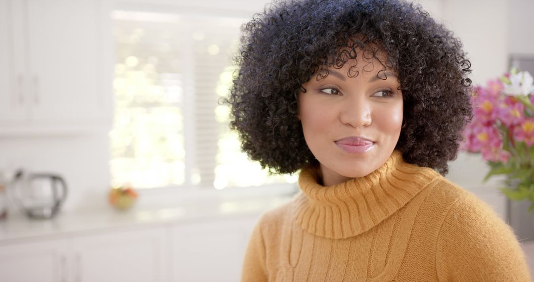 Smiling Woman in Cozy Sweater with Curly Hair at Home - Free Images, Stock Photos and Pictures on Pikwizard.com