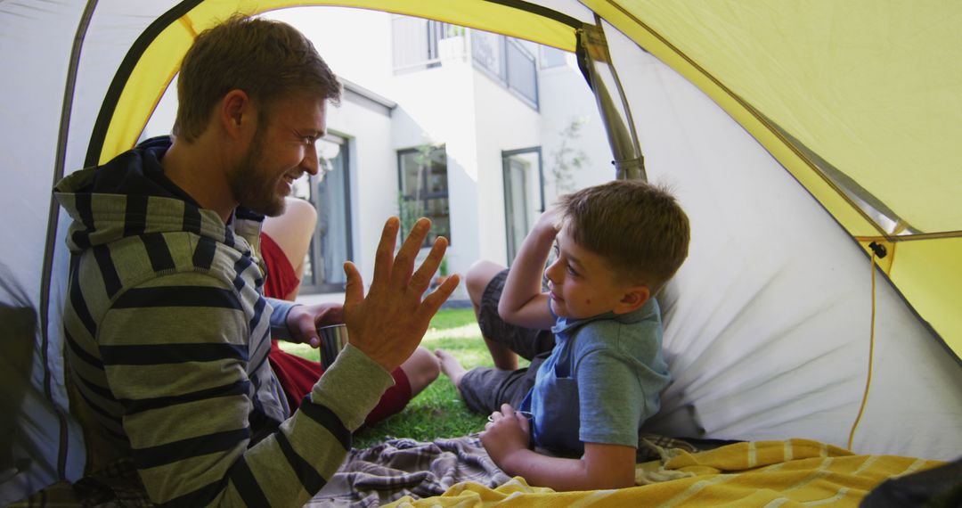 Father and Son Bonding in Tent Outdoors - Free Images, Stock Photos and Pictures on Pikwizard.com