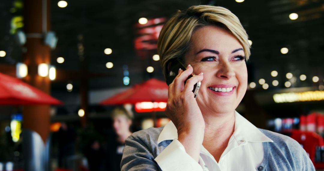 Senior Businesswoman Talking on Smartphone, Smiling in Modern Office Building - Free Images, Stock Photos and Pictures on Pikwizard.com