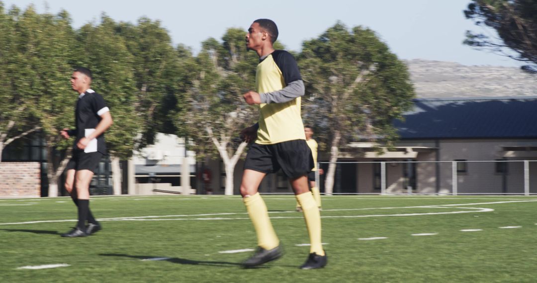 Soccer Player Relaxing on Field During Sunny Day