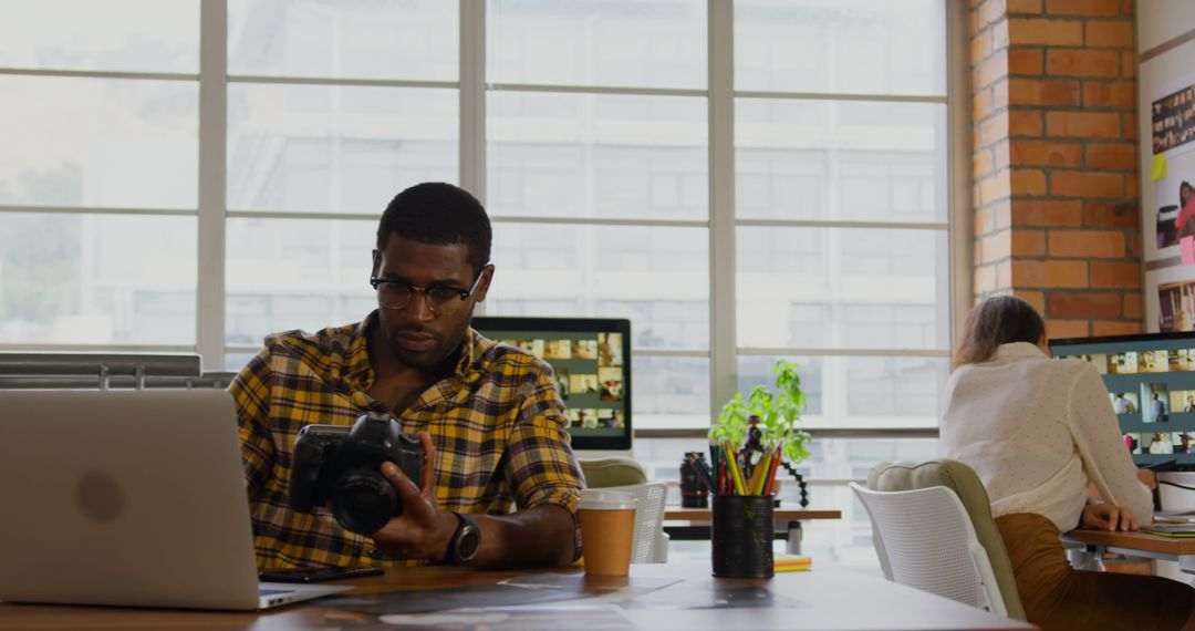 Creative Graphic Designer Reviewing Photos in Modern Office