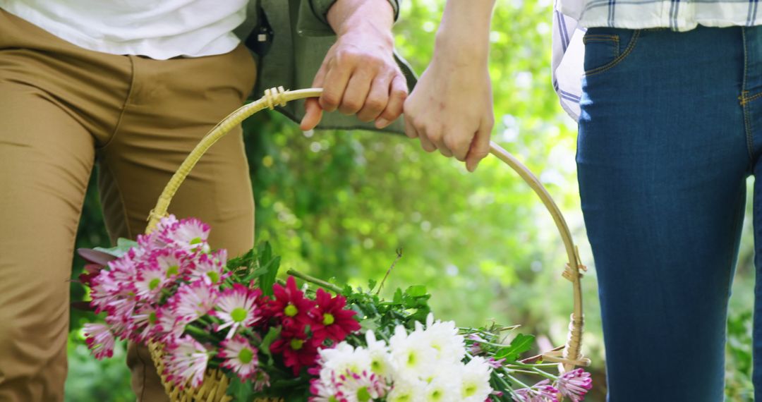 Couple Carrying Basket of Fresh Flowers in Garden - Free Images, Stock Photos and Pictures on Pikwizard.com