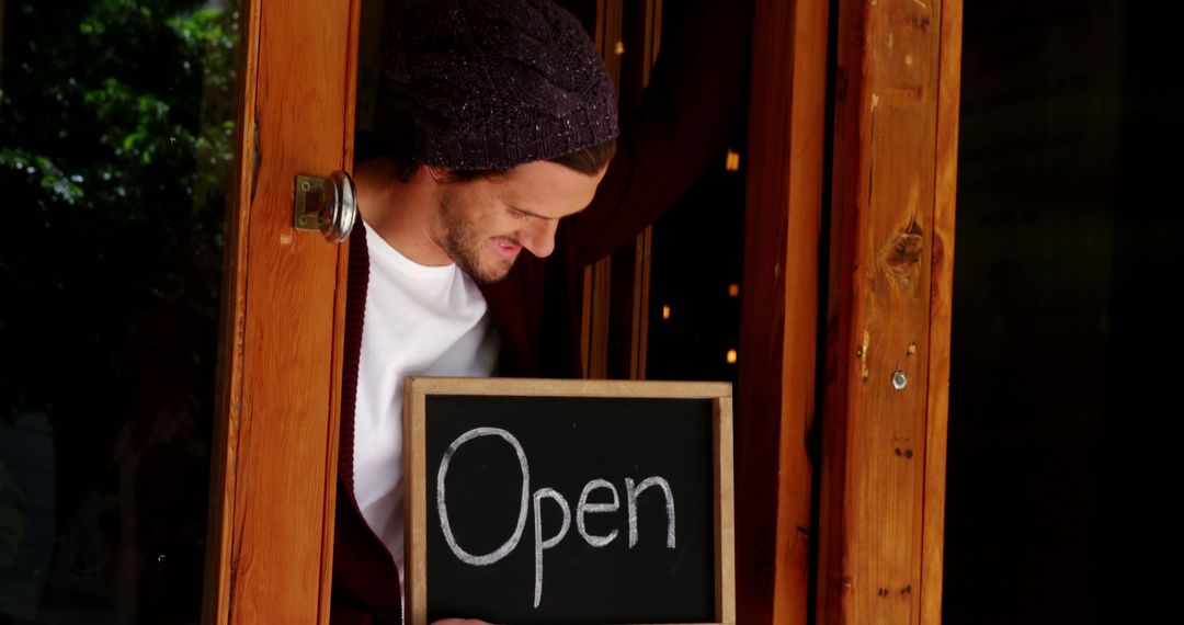 Cafe Owner Holding Open Sign at Door - Free Images, Stock Photos and Pictures on Pikwizard.com