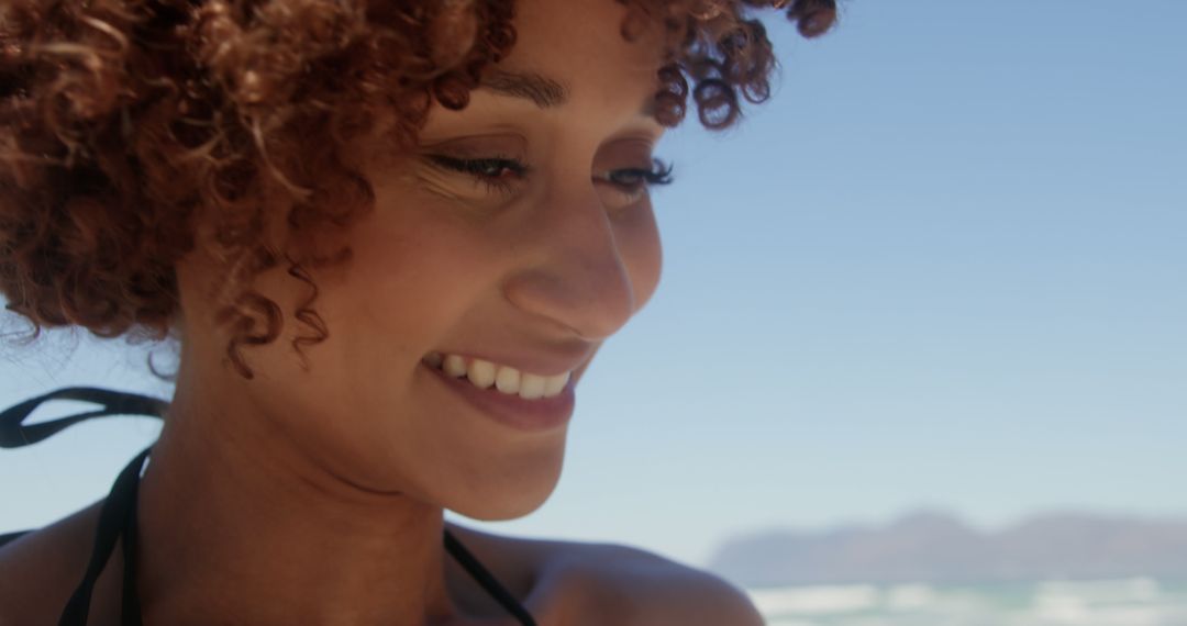 Close-up of smiling woman on a sunny beach day - Free Images, Stock Photos and Pictures on Pikwizard.com