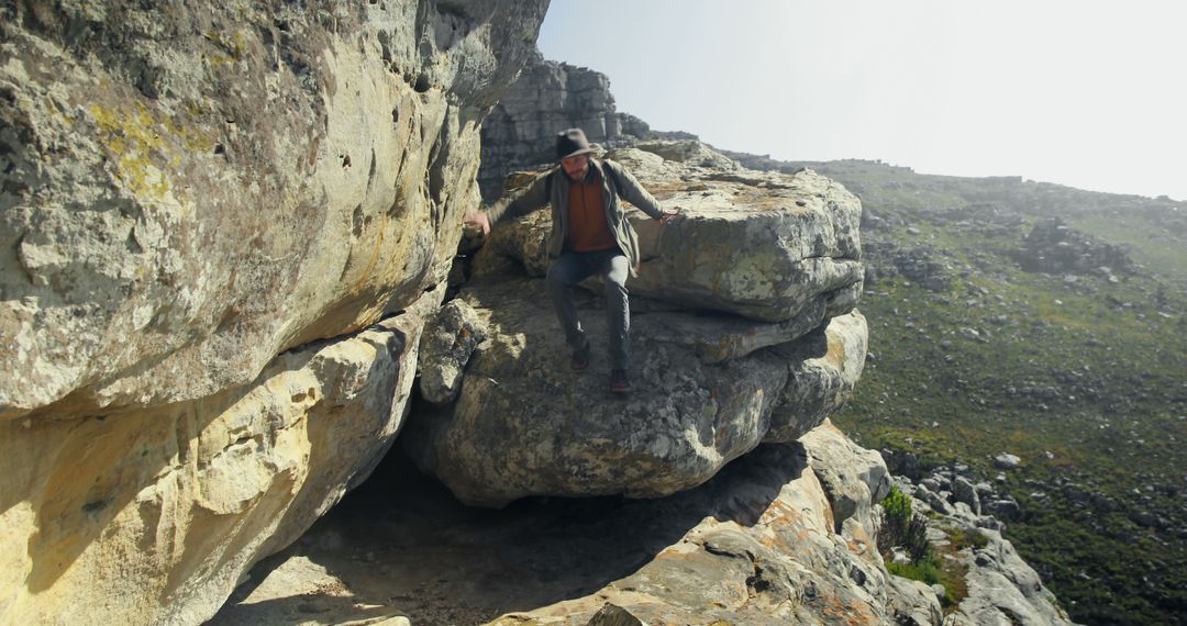 Adventurer Climbing on Rocky Mountain Cliffside - Free Images, Stock Photos and Pictures on Pikwizard.com