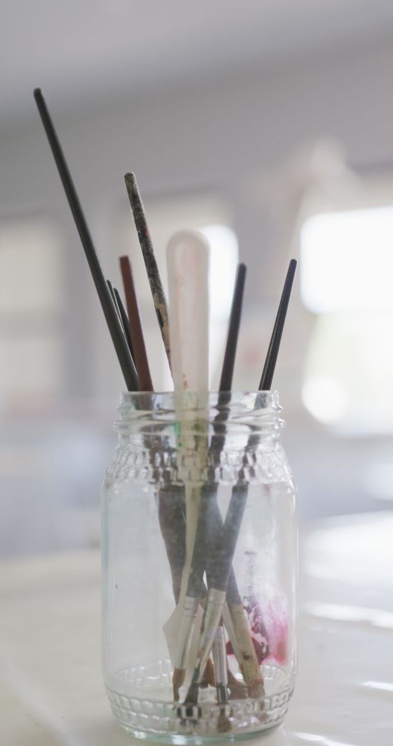 Art Brushes in Mason Jar in Softly Lit Classroom