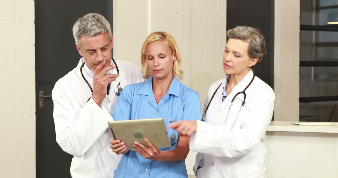 Medical Professionals Reviewing Patient Data on Tablet - Free Images, Stock Photos and Pictures on Pikwizard.com