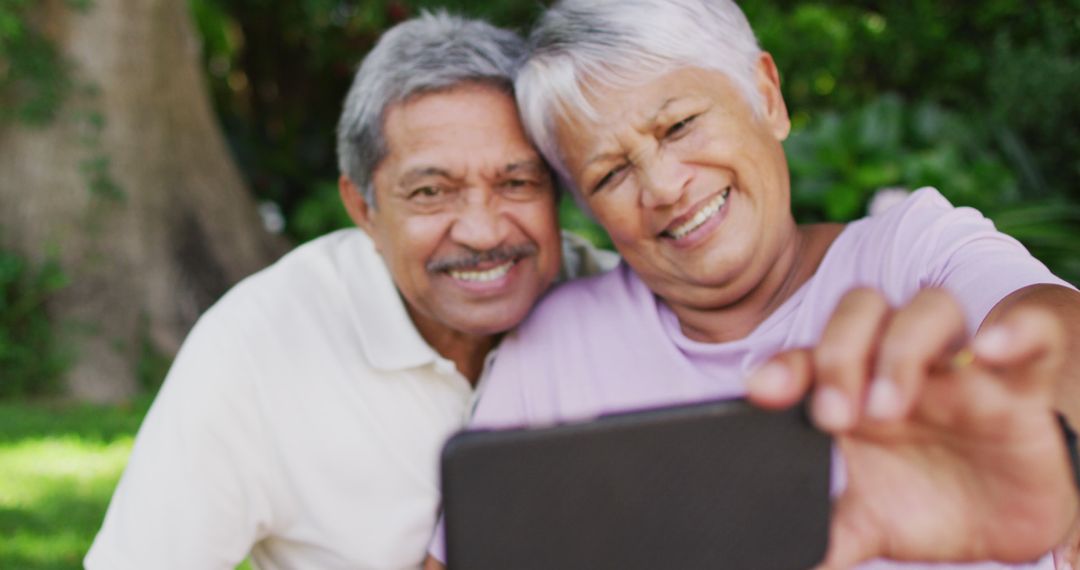 Image of happy biracial senior couple taking selfie in garden - Free Images, Stock Photos and Pictures on Pikwizard.com