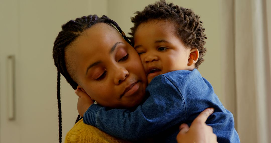 Tender Moment: Mother Embracing Her Young Son at Home