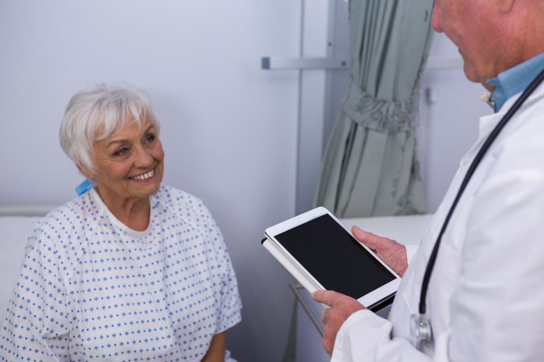 Doctor interacting with senior patient in ward - Free Images, Stock Photos and Pictures on Pikwizard.com