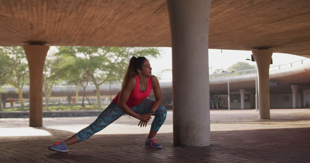 Young woman stretching under bridge during morning workout - Free Images, Stock Photos and Pictures on Pikwizard.com