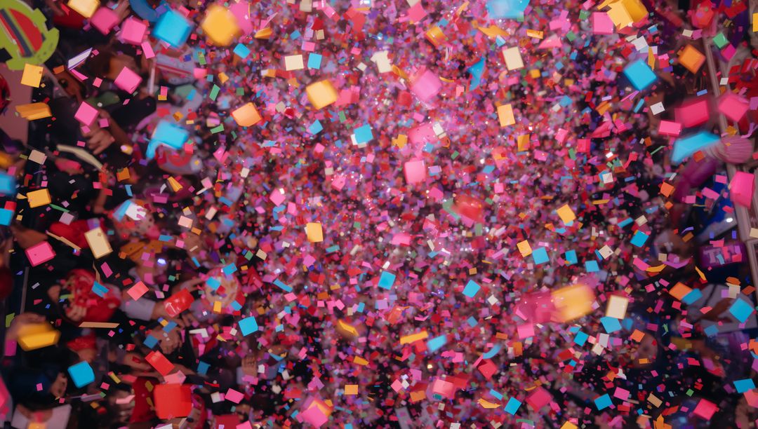 Square Confetti Shower Bursting Over Concert Crowd With Neon Lights and Smartphone Glow
