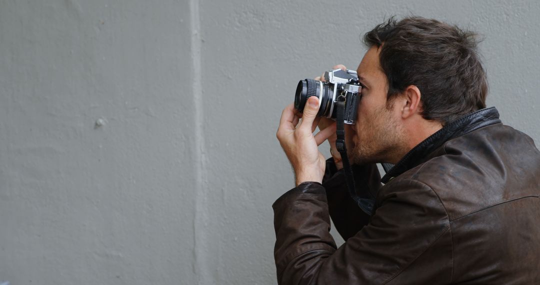 Male Photographer Taking Photos with Vintage Camera - Free Images, Stock Photos and Pictures on Pikwizard.com