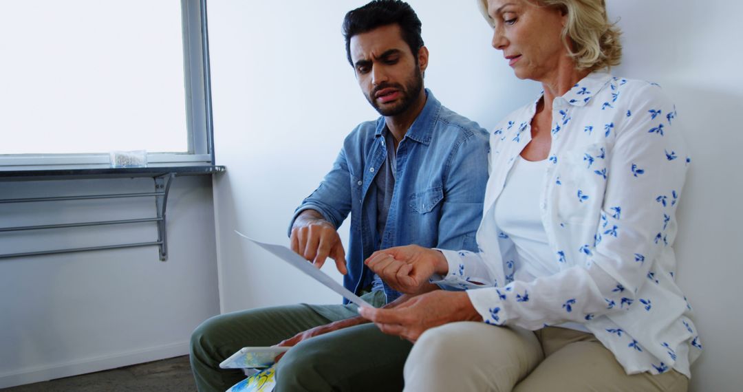 Diverse Colleagues Reviewing Documents in Modern Workspace