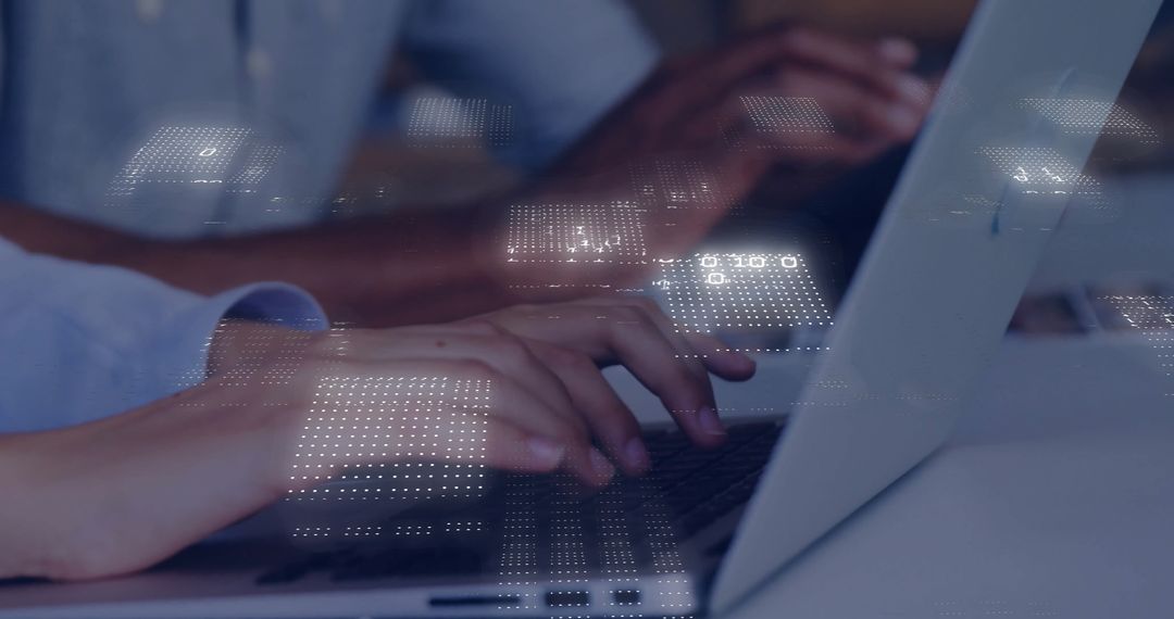 Hands Typing on Laptops with Futuristic Digital Overlay