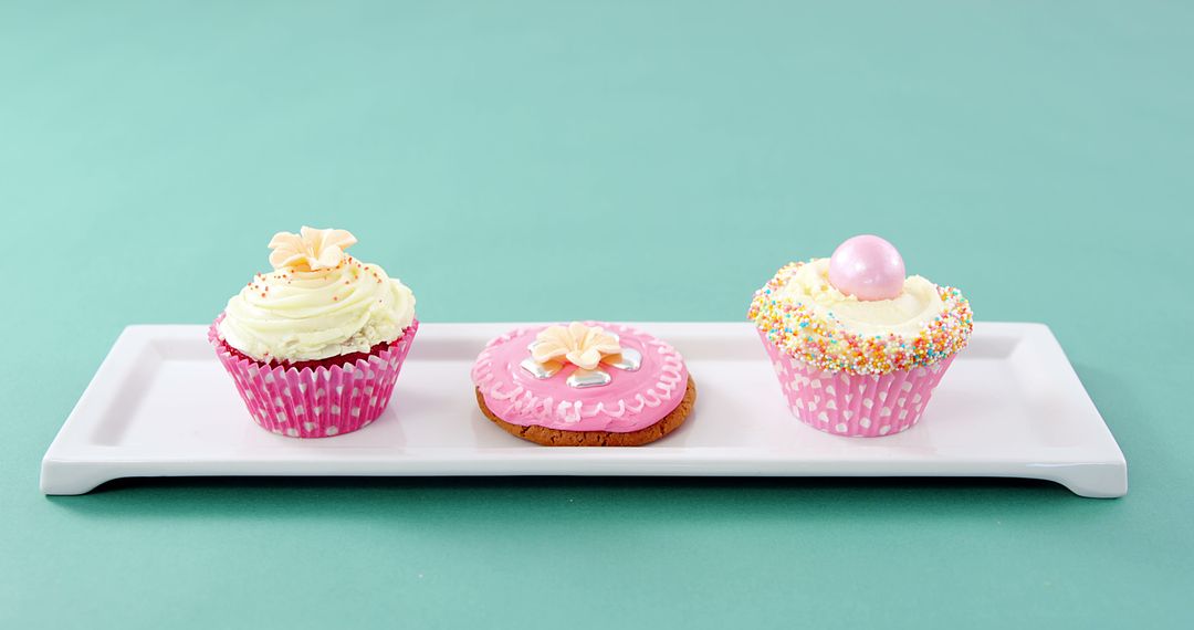 Beautifully Decorated Cupcakes and Cookie on White Platter - Free Images, Stock Photos and Pictures on Pikwizard.com