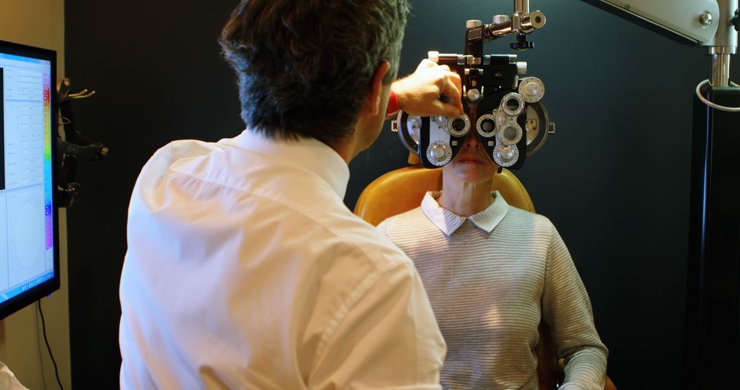 Optician Examining Patient with Phoropter in Modern Clinic - Free Images, Stock Photos and Pictures on Pikwizard.com