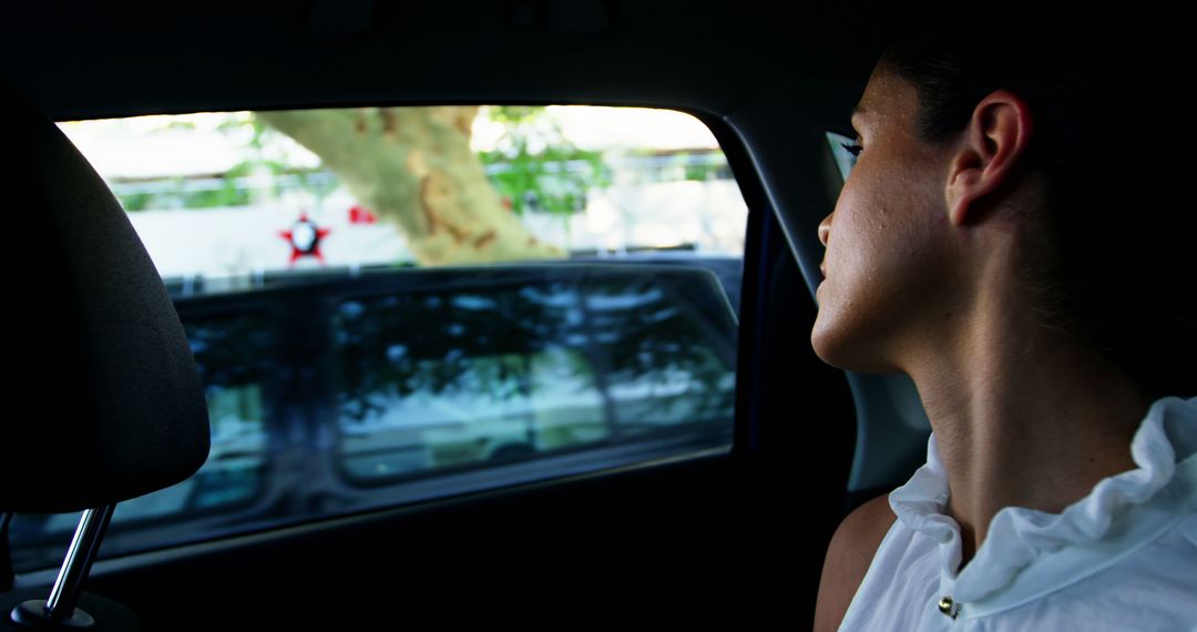 Woman Looking Out Car Window on Sunny Day - Free Images, Stock Photos and Pictures on Pikwizard.com