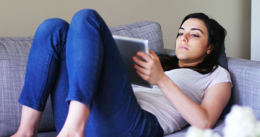 Woman Relaxing on Couch with Tablet in Casual Outfit - Free Images, Stock Photos and Pictures on Pikwizard.com