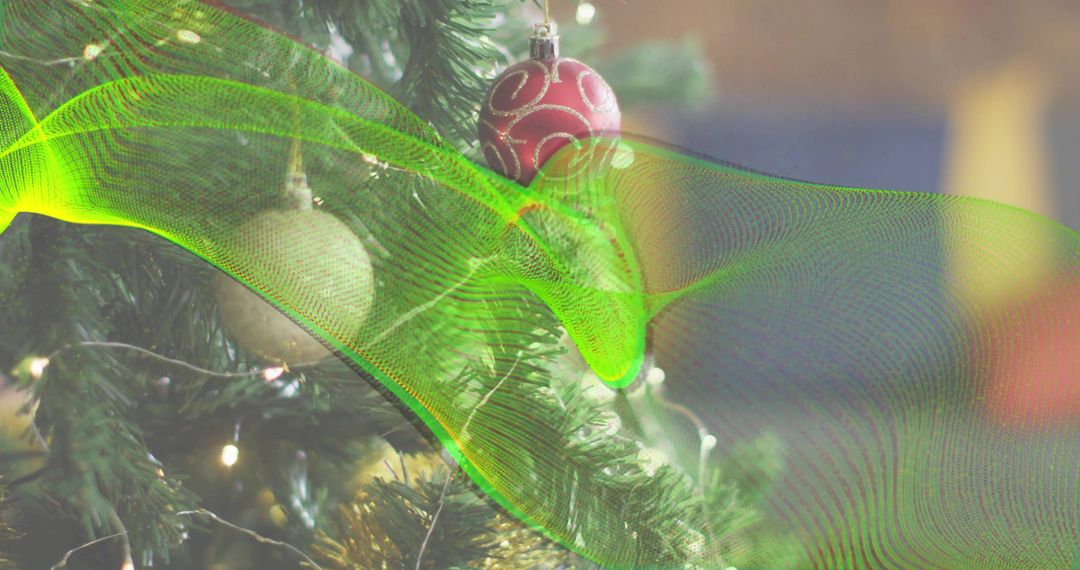 Glowing red bauble on evergreen branch with neon green wave overlay and warm bokeh