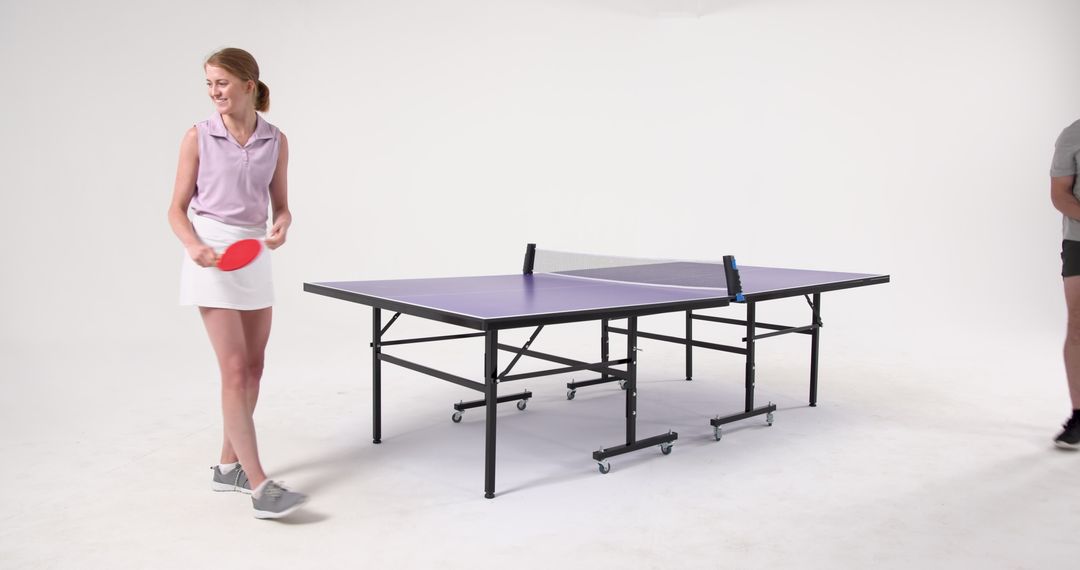Active Friends Enjoying Table Tennis in Modern Studio Setting