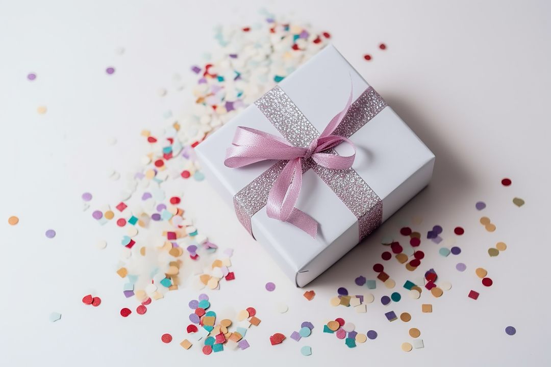 Elegant Gift Box with Confetti on White Background
