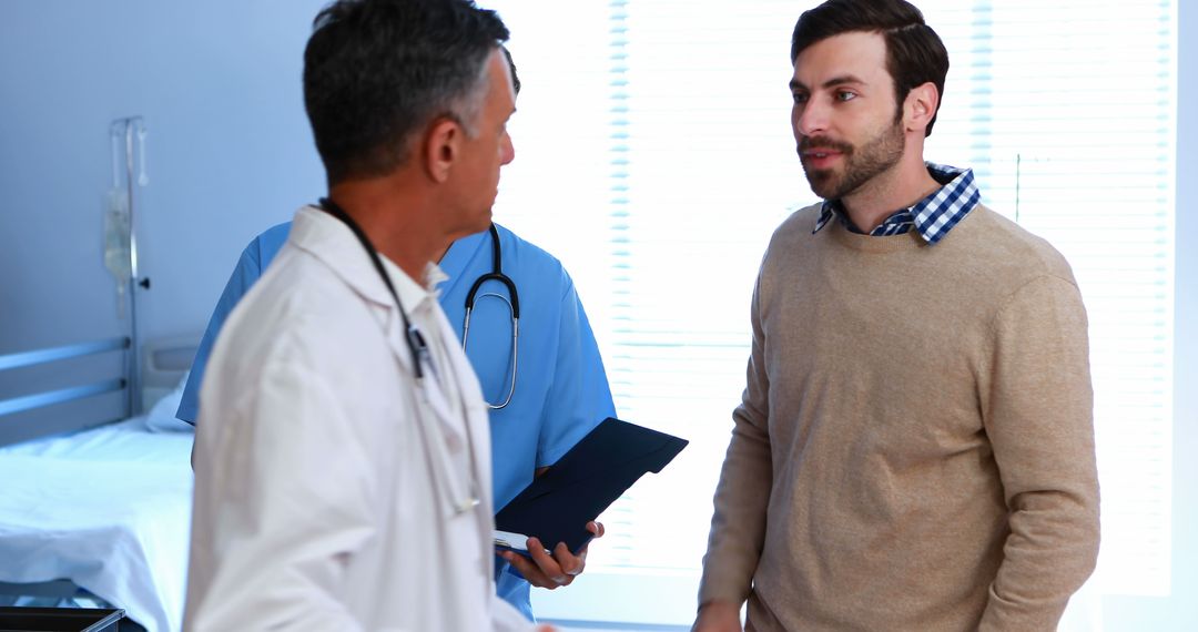 Patient Discussing Health Concerns with Medical Professionals in Clinic - Free Images, Stock Photos and Pictures on Pikwizard.com