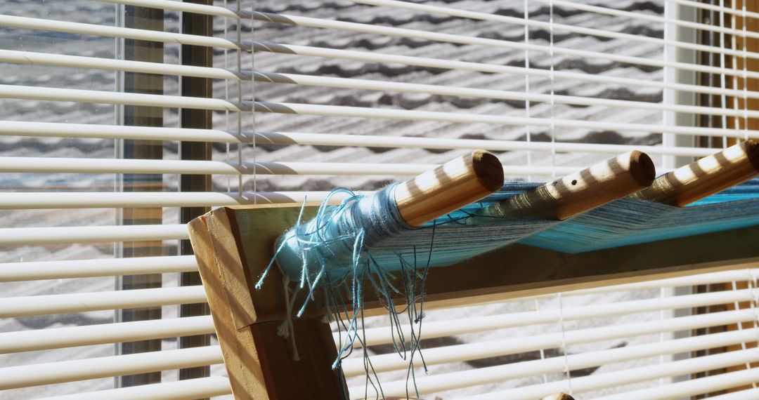 Close-Up of Threads on Inkle Loom in Sunlit Workshop