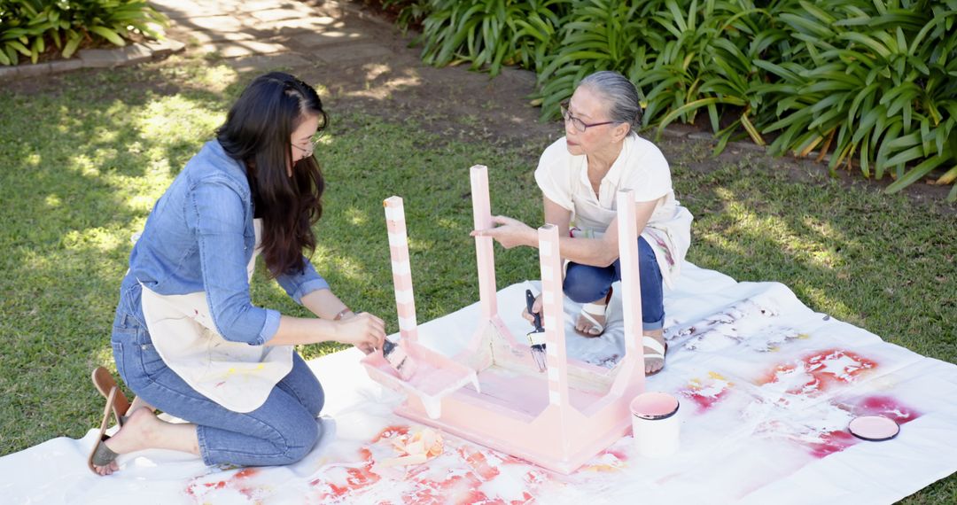 Mother and Daughter Restoring Furniture in Garden